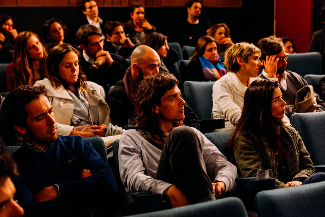 Audience members watching a business presentation
